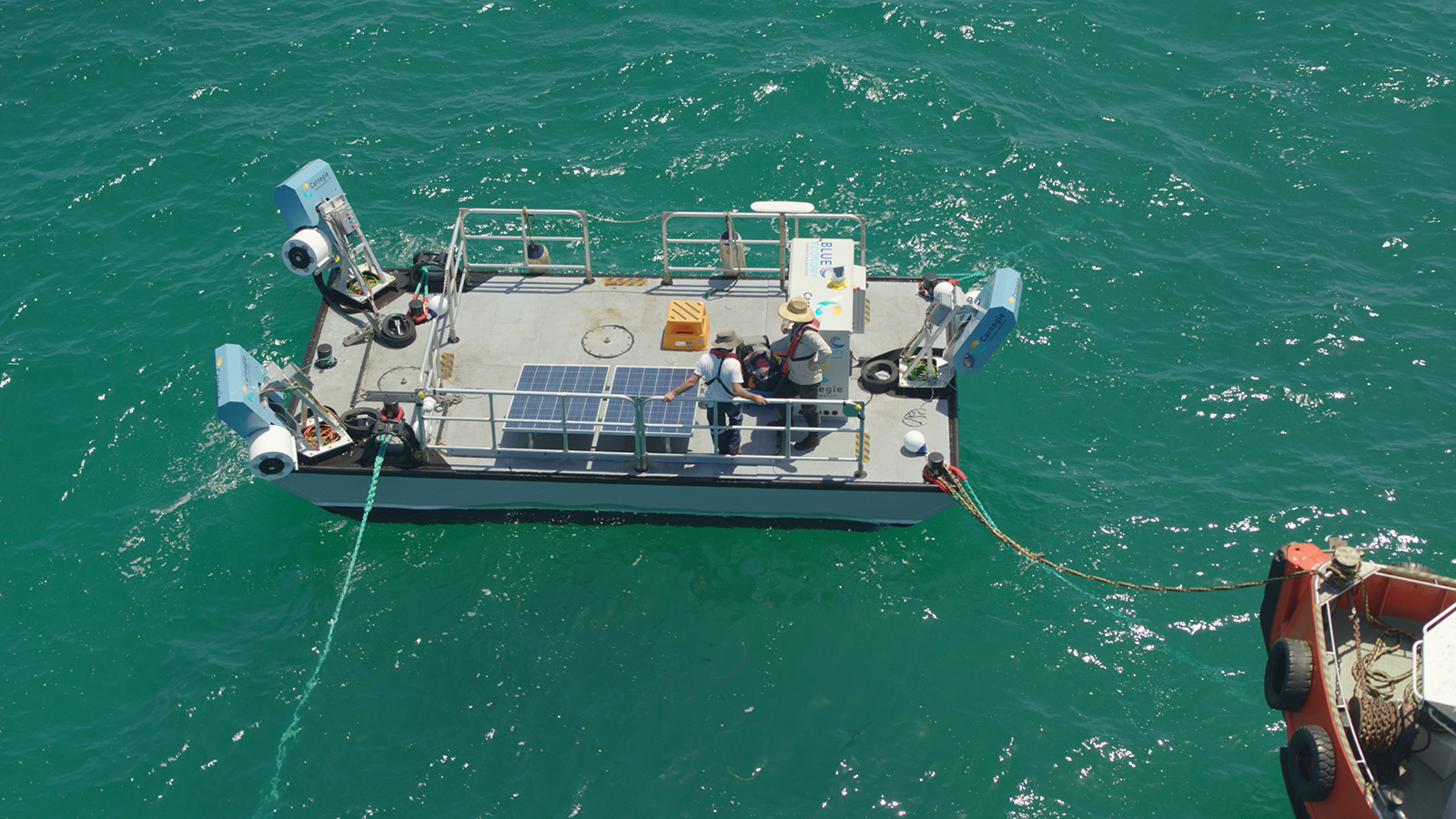 Aerial view of prototype boat equipped with epic power bidirectional dc dc converter, able to store ocean waves energy to reuse it.